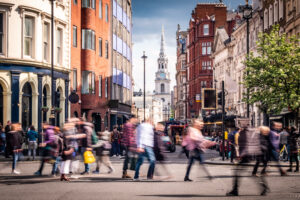 Motion blurred people on busy street in London's West End, UK