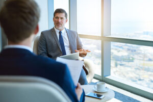 Mature businessman holing an interview with young applicant