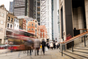 London city street scene with financial buildings and motion blurred people