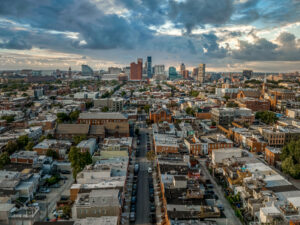 Aerial view of high rise office buildings in downtown Baltimore and the Federal Hill neighborhood with brick facades