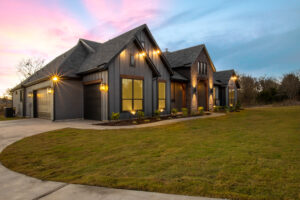 Exterior Modern Farmhouse at Dusk with Pink and Blue Sky From an Angle