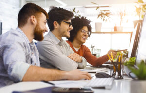 Group of People Sitting Around a Computer, Have Conversation