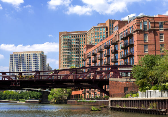 Apartment buildings and the Grand Avenue bridge in the River North district of Chicago on a bright summer day.