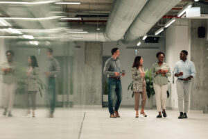 Diverse business team walking through modern office discussing work