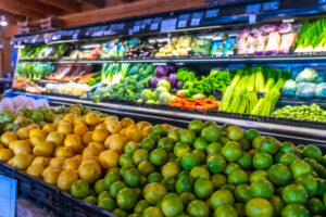 Fresh limes and lemons displayed in grocery store produce section