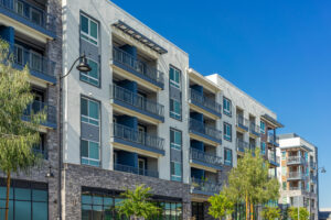 New modern apartment building with balconies and blue sky